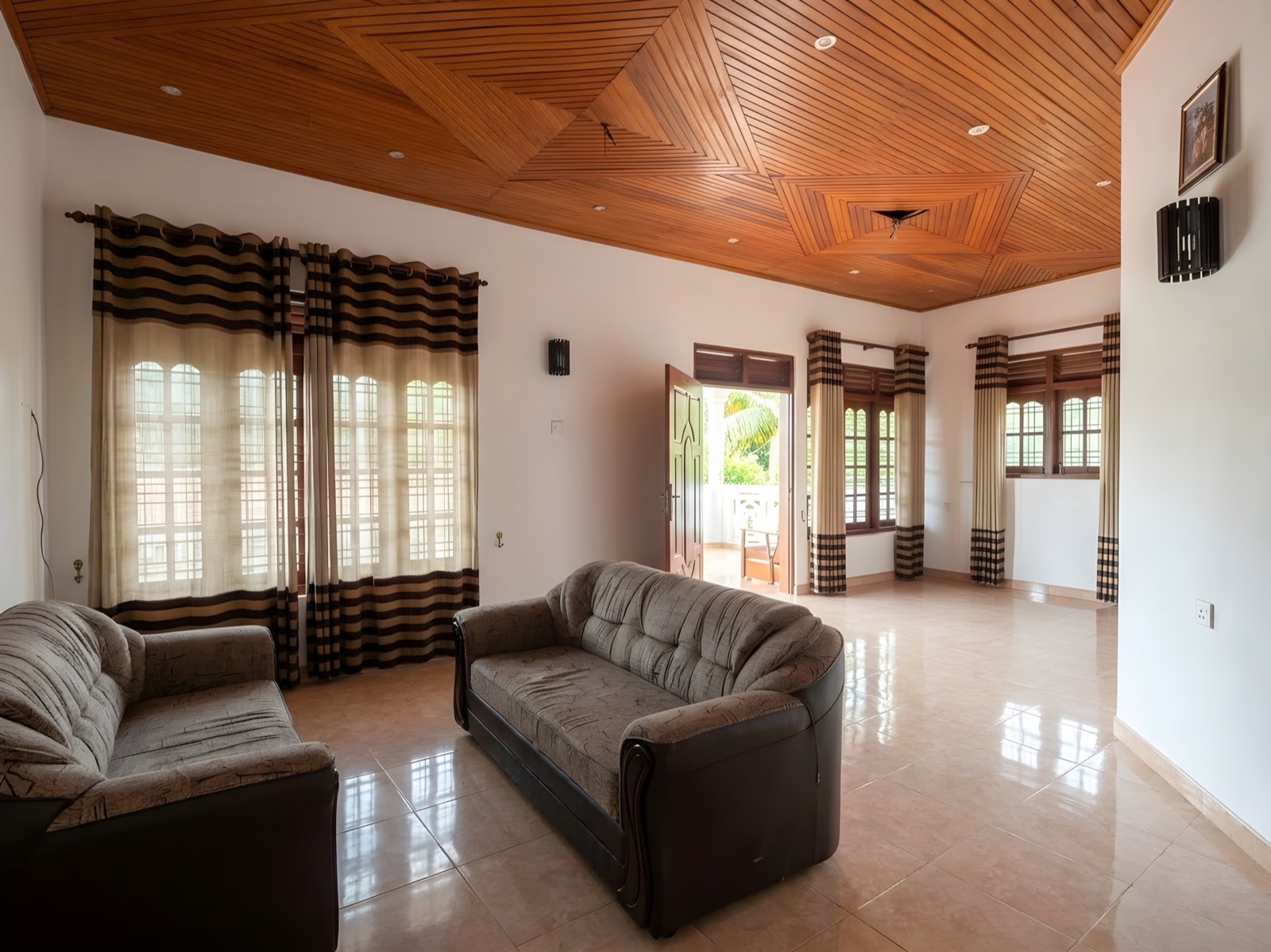 Bright living room with sofas and a timber ceiling